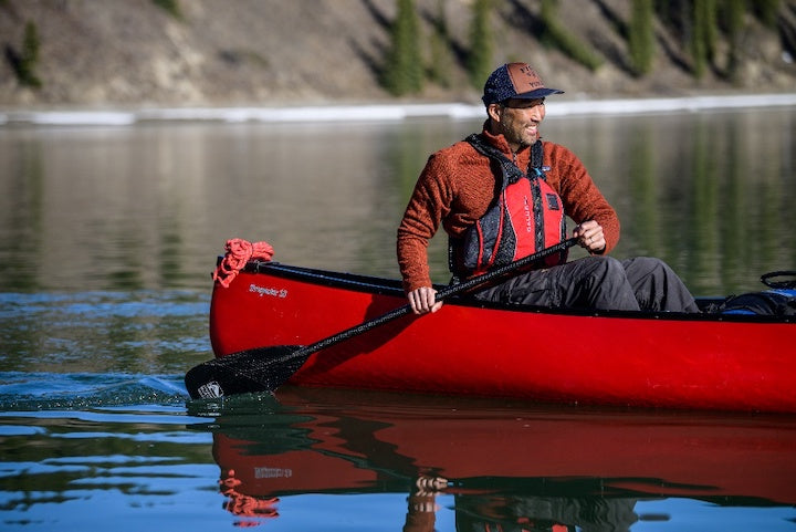 man paddling a red canoe with Black Pearl 11 canoe paddle