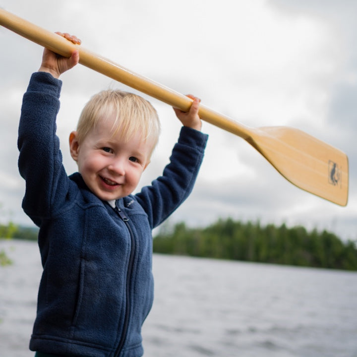 little boy with child-size canoe paddle