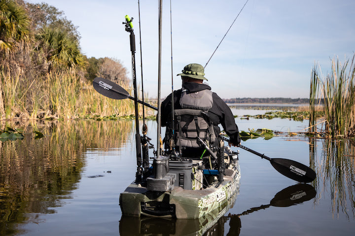 man in his fishing kayak, paddling