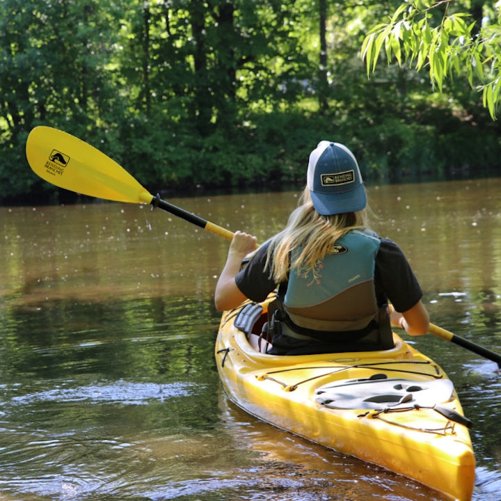 woman kayaking on a small lake or river